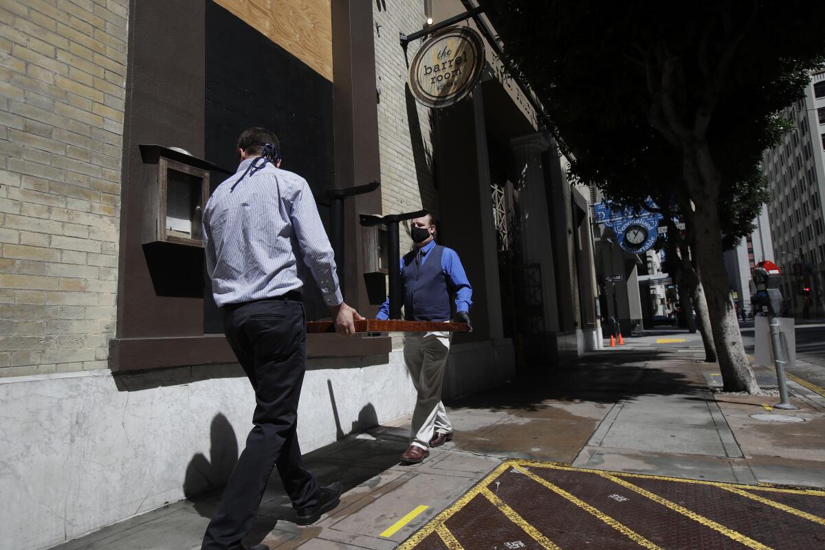 Employees at the Barrel Room set tables outside of the restaurant in San Francisco 