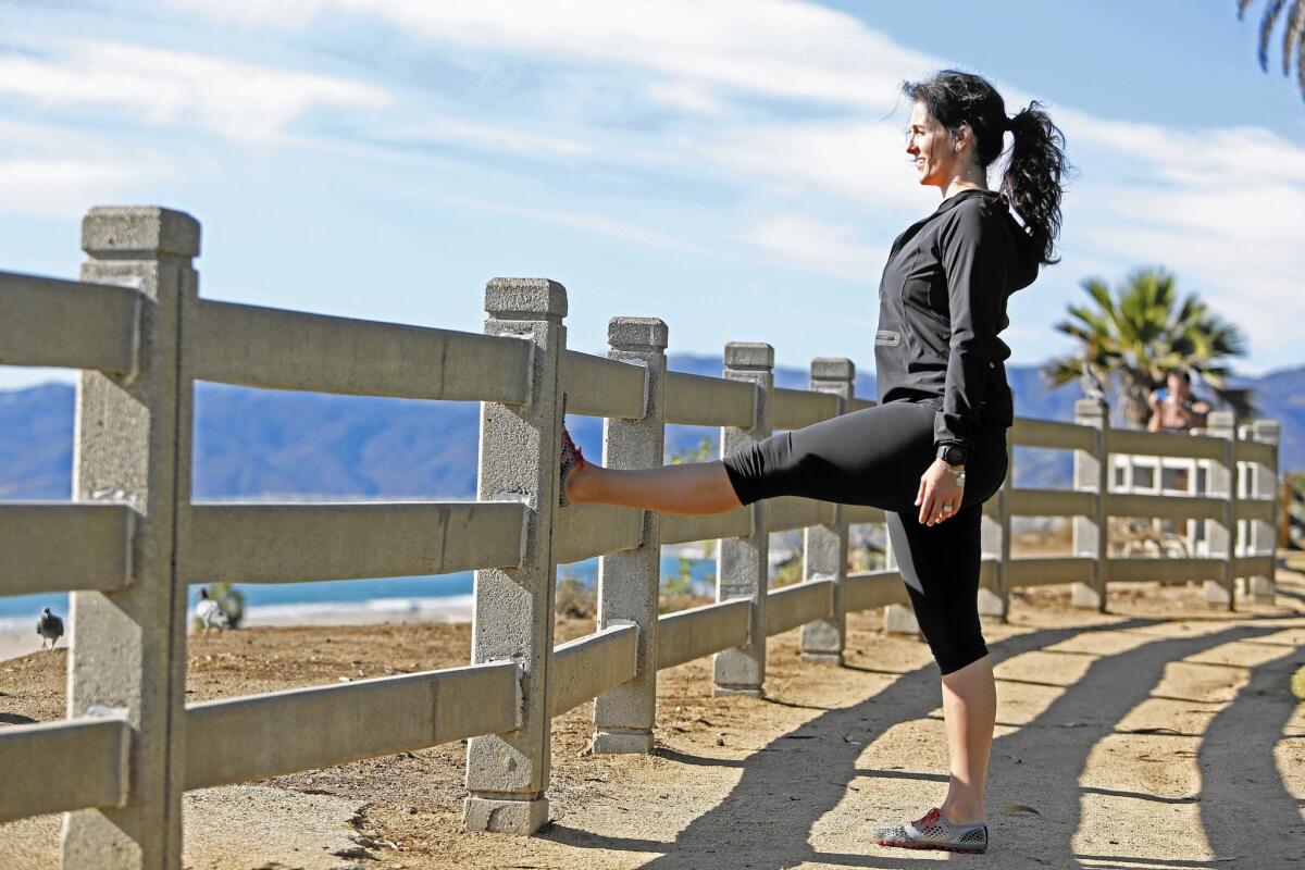 Trainer Amanda Joyce finds a beautiful spot for a hamstring stretch at Santa Monica's Palisades Park overlooking the ocean.