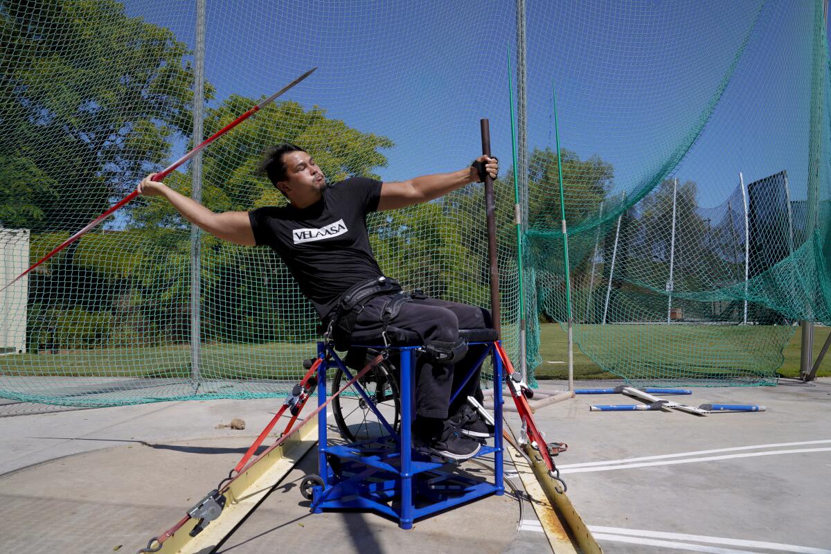 Justin Phongsavanh practices with his javelin in an adaptive throwing chair at the Chula Vista Elite Athlete Training Center.