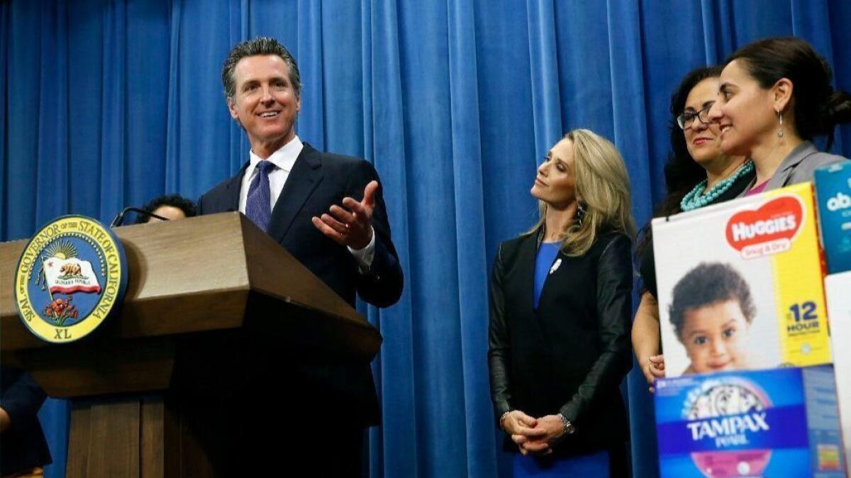 Gov. Gavin Newsom discusses a proposal to eliminate the state sales tax on tampons and diapers in his upcoming state budget during a news conference on Tuesday in Sacramento.