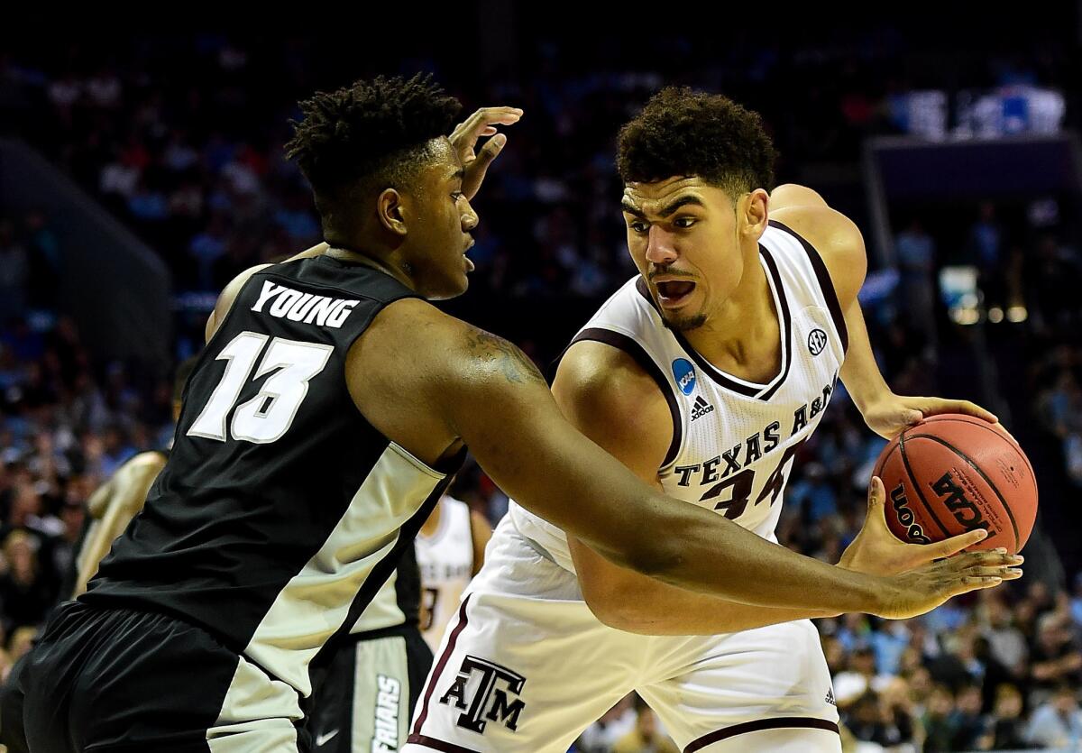 Providence's Kalif Young defends against Texas A&M's Tyler Davis.