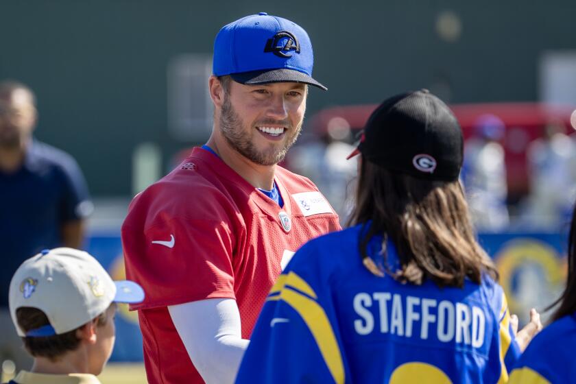 Irvine, CA - July 27: Rams quarterback Matthew Stafford greets fans as he arrives at Rams training camp.