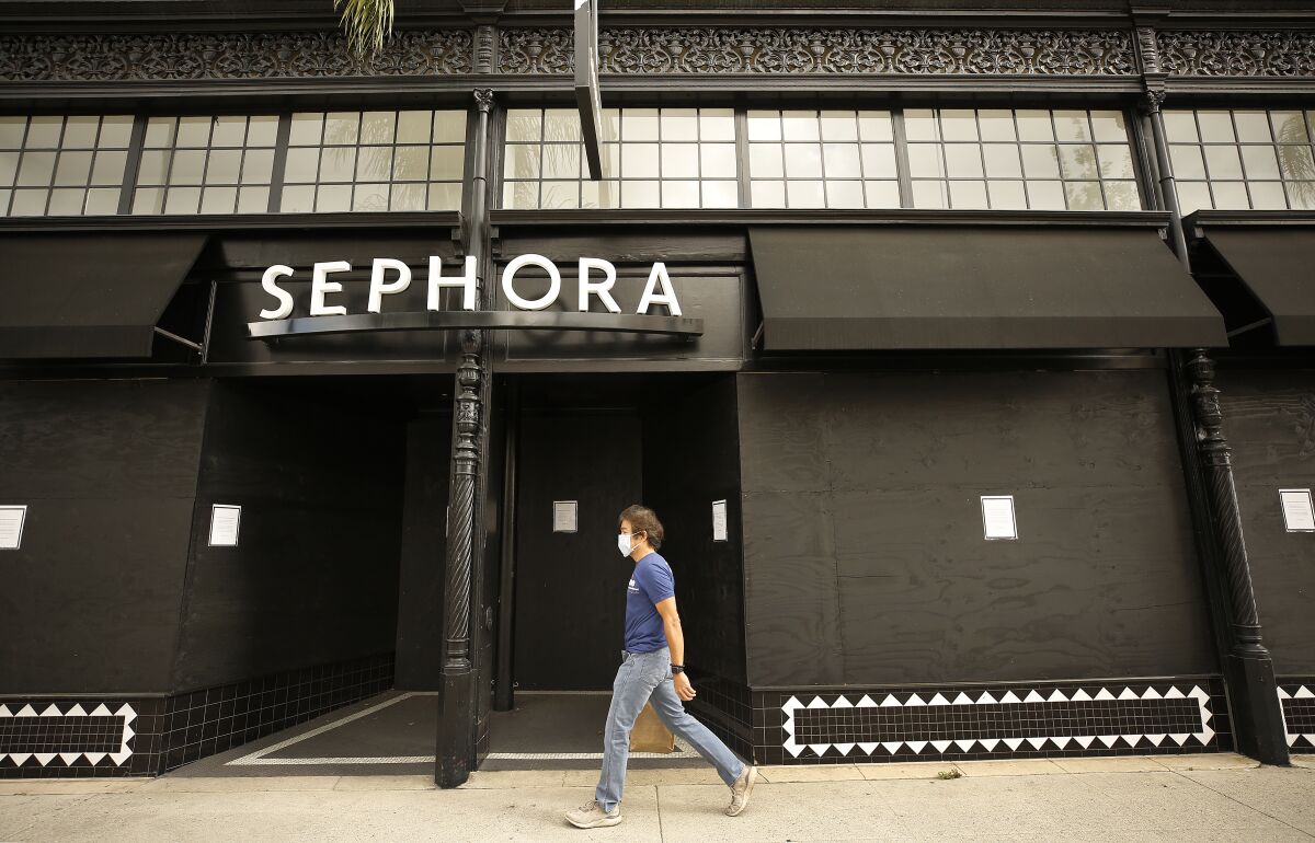 Doy Estacio walks past a closed Sephora store on Colorado Boulevard in Pasadena on April 2.
