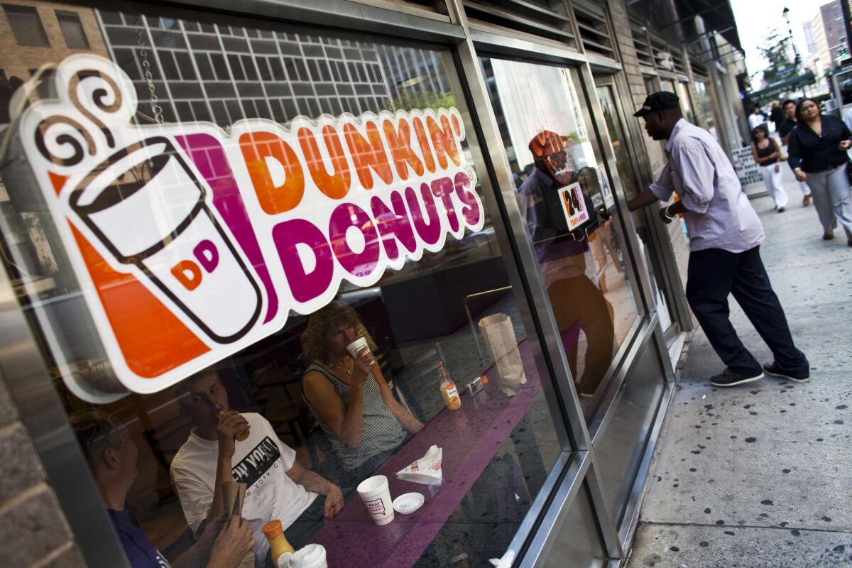 A customer enters a Dunkin' Donuts store in midtown Manhattan in 2011.