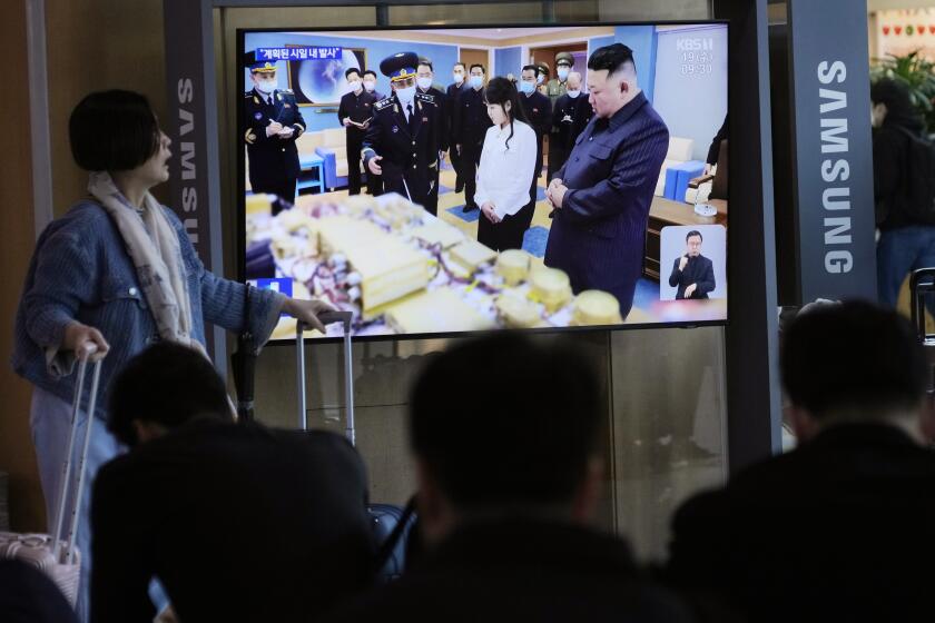 A TV screen shows an image of North Korean leader Kim Jong Un, right, and his daughter during a news program at the Seoul Railway Station in Seoul, South Korea, Wednesday, April 19, 2023. Kim said his country has completed the development of its first military spy satellite and ordered officials to go ahead with its launch as planned, state media reported Wednesday. (AP Photo/Ahn Young-joon)