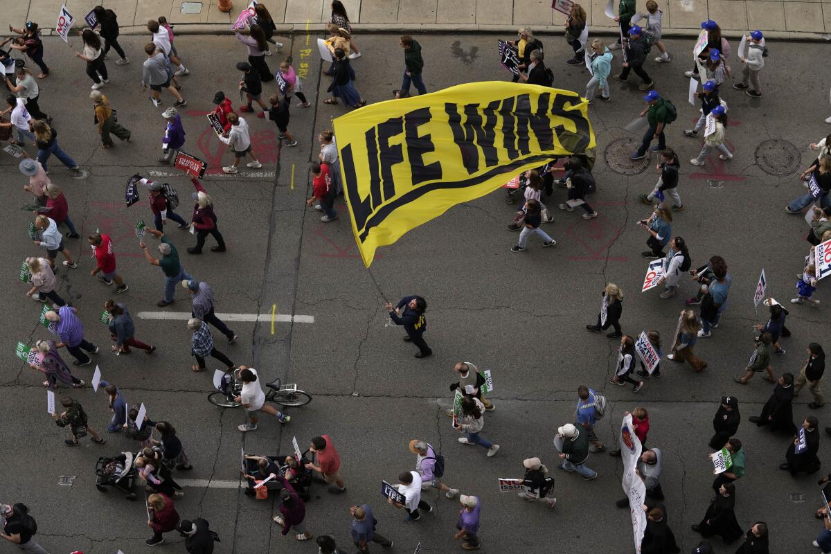 Marchers hold a "life wins" banner during the Ohio March for Life in Columbus, Ohio.