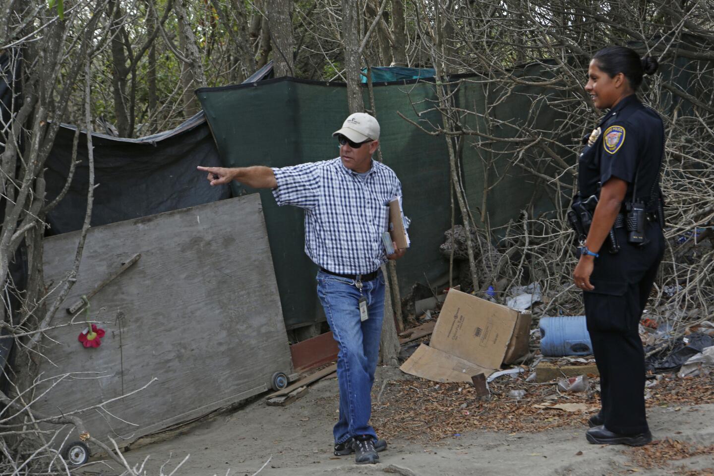 Community services manager of Ventura and Oxnard Peter Brown, left, at a homeless encampment on 5th Street in Oxnard.