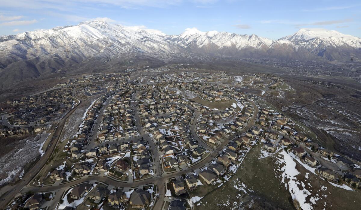 FILE - Rows of homes, in suburban Salt Lake City, on April 13, 2019. Utah is one of two Western states known for rugged landscapes and wide-open spaces that are bucking the trend of sluggish U.S. population growth. The boom there and in Idaho are accompanied by healthy economic expansion, but also concern about strain on infrastructure and soaring housing prices. (AP Photo/Rick Bowmer, File)