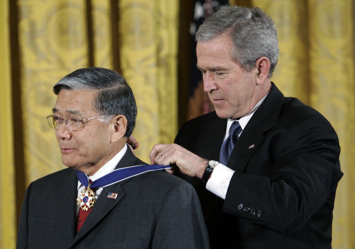 President Bush bestows the Presidential Medal of Freedom to former Transportation Secretary Norman Y. Mineta