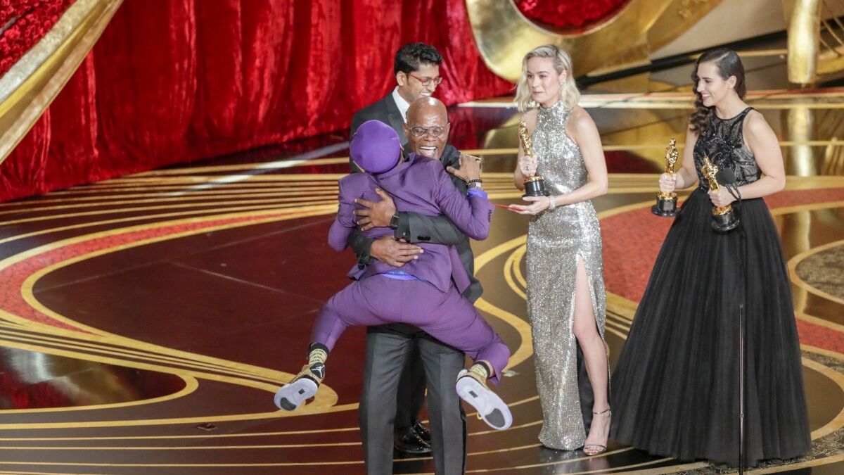 Spike Lee embraces presenter Samuel L. Jackson as he accepts the adapted screenplay award for 'BlacKkKlansman' at the 91st Academy Awards.