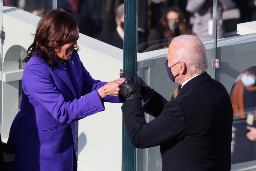WASHINGTON, DC - JANUARY 20: Vice President Kamala Harris celebrates with President-elect Joe Biden after being sworn in during the inauguration on the West Front of the U.S. Capitol on January 20, 2021 in Washington, DC. During today's inauguration ceremony Joe Biden becomes the 46th president of the United States. (Photo by Tasos Katopodis/Getty Images)