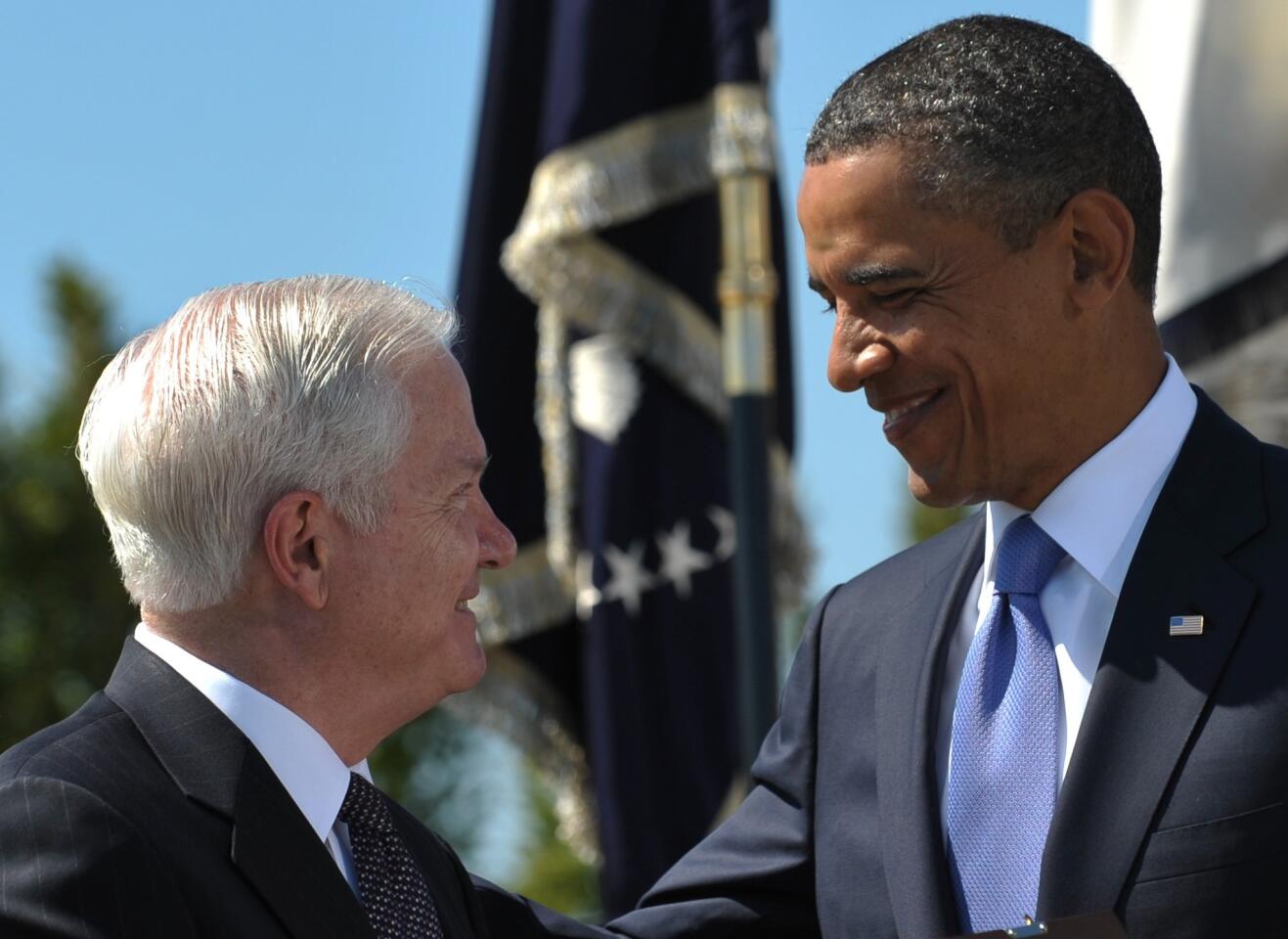 President Obama smiles at outgoing U.S. Defense Secretary Robert Gates after presenting him the Medal of Freedom during the Armed Forces Farewell Tribute in honor of Gates at the Pentagon in Washington, D.C., in 2011.