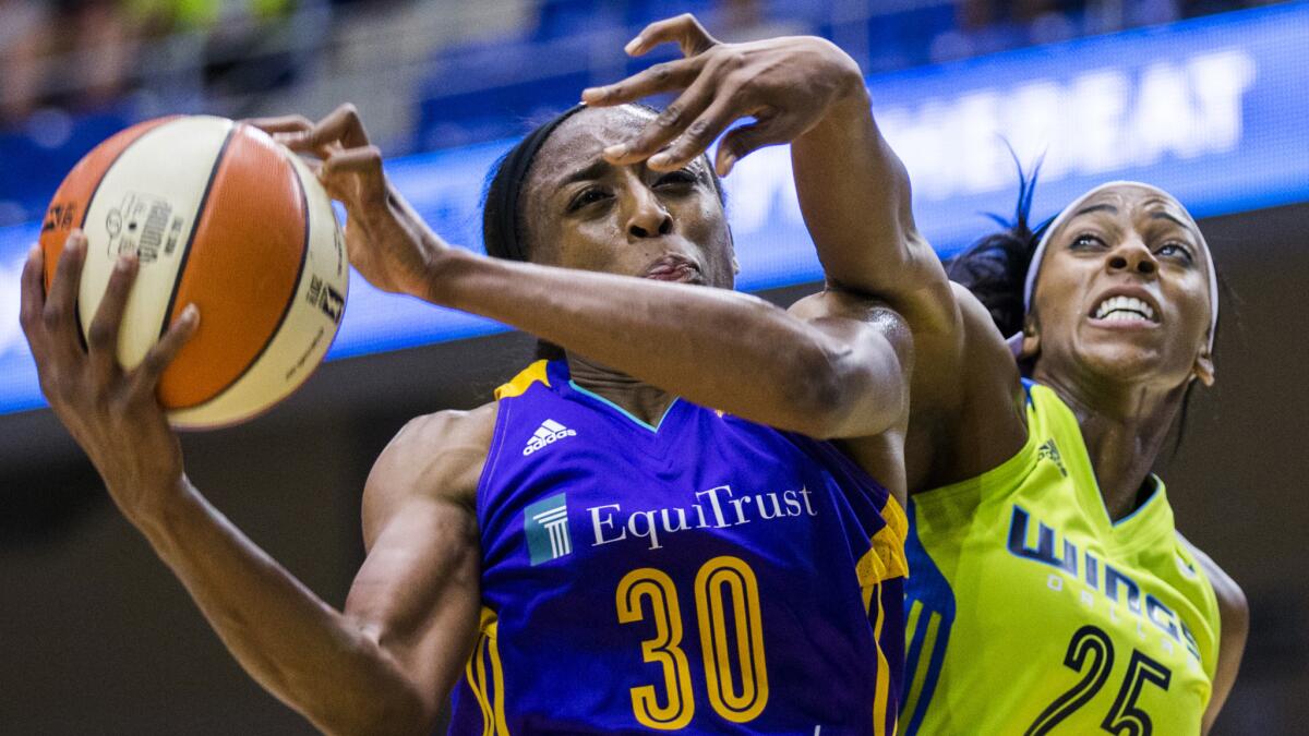 Sparks forward Nneka Ogwumike (30) tries to score against Wings forward Glory Johnson in the first half Saturday.