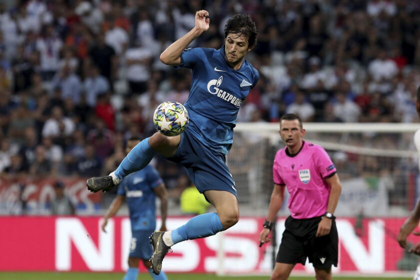 FILE - Zenit's Sardar Azmoun goes for the ball during the group G Champions League soccer match between Lyon and Zenit St Petersburg at the Lyon Olympic Stadium in Lyon, France, Tuesday, Sept. 17, 2019. Iran forward Sardar Azmoun is a doubt for the World Cup after picking up an injury while warming up for Bayer Leverkusen, the Bundesliga club said late Thursday, Oct. 6, 2022. (AP Photo/Laurent Cipriani, File)