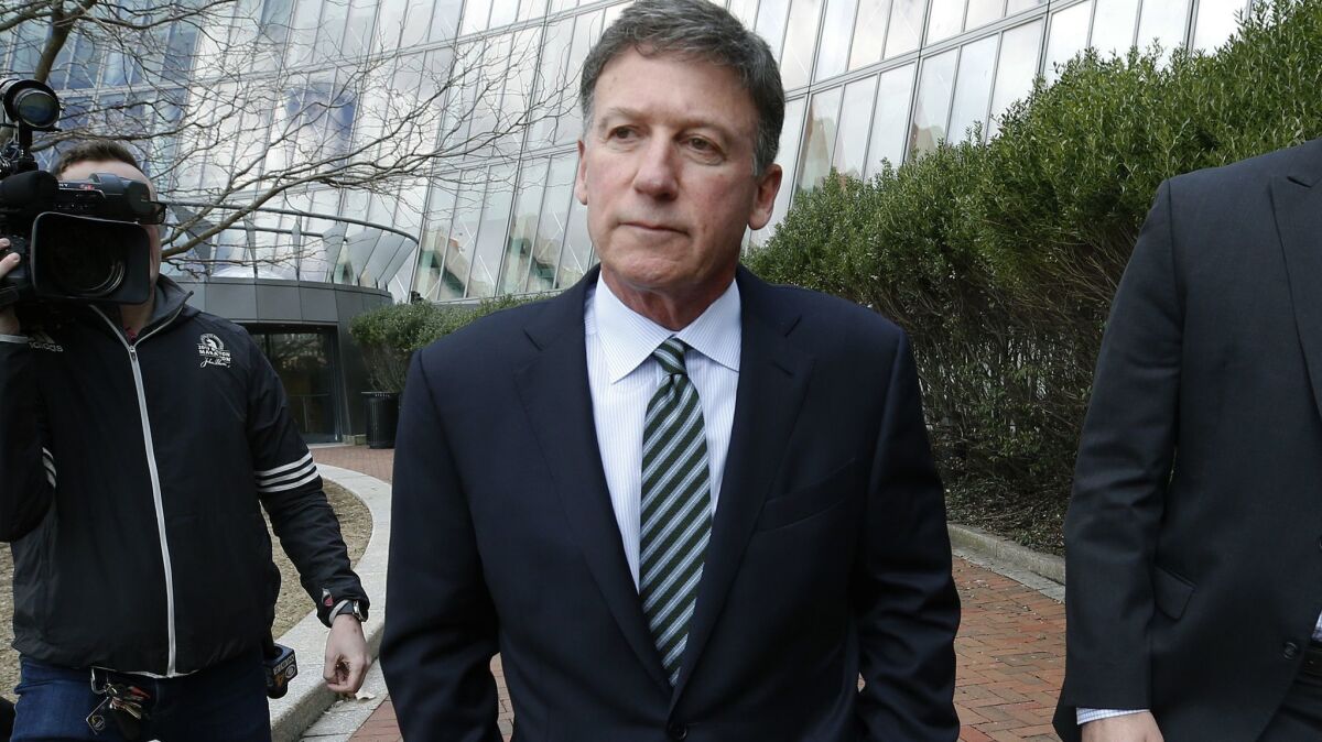 Bruce Isackson departs federal court in Boston on April 3 after facing charges in a nationwide college admissions bribery scandal.