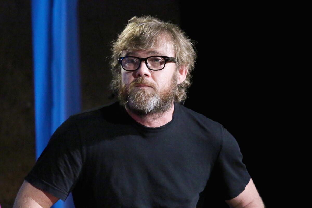 Ricky Schroder with a beard and glasses and wearing a black T-shirt
