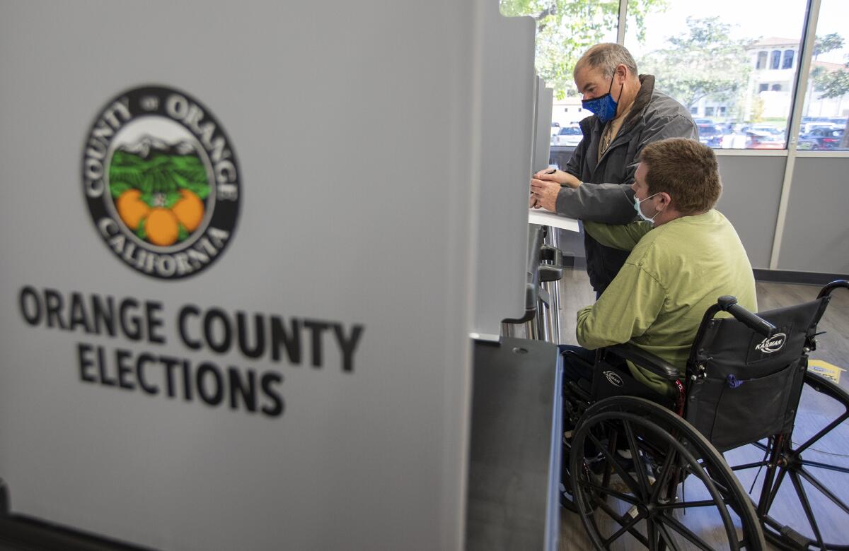 Burgess Norminton and his son Cole vote in a special election Tuesday at Costa Mesa City Hall