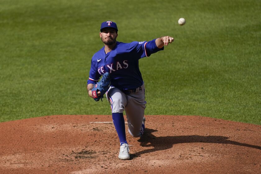 Texas Rangers starting pitcher Andrew Heaney throws a pitch to the Baltimore Orioles during the second inning of a baseball game, Saturday, May 27, 2023, in Baltimore. (AP Photo/Julio Cortez)