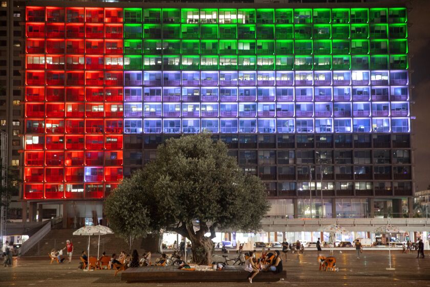 FILE - In this Aug. 13, 2020, file photo, Tel Aviv City Hall is lit up with the flag of the United Arab Emirates as UAE and Israel announced they would be establishing full diplomatic ties, in Tel Aviv, Israel.Iran’s powerful Revolutionary Guard vowed on Saturday, Aug. 15, 2020 that there would be dangerous consequences for the United Arab Emirates after it announced a historic deal with Israel to open up diplomatic relations. (AP Photo/Oded Balilty, File)