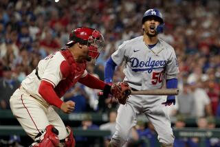 St. Louis Cardinals catcher Willson Contreras, left, celebrates as Los Angeles Dodgers' Mookie Betts reacts.