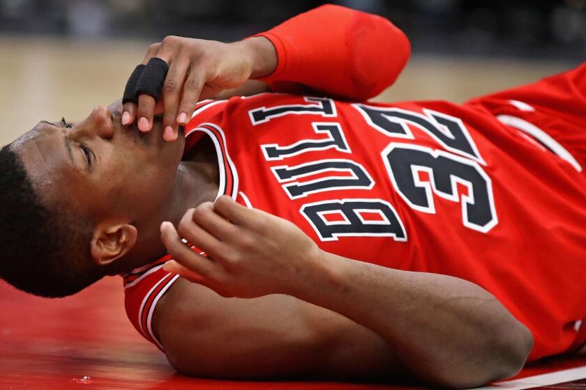 CHICAGO, IL - JANUARY 17: Kris Dunn #32 of the Chicago Bulls lays on the floor after suffering a mouth injury following a dunk against the Golden State Warriors at the United Center on January 17, 2018 in Chicago, Illinois. The Warriors defeated the Bulls 119-112. NOTE TO USER: User expressly acknowledges and agrees that, by downloading and or using this photograph, User is consenting to the terms and conditions of the Getty Images License Agreement. (Photo by Jonathan Daniel/Getty Images) ** OUTS - ELSENT, FPG, CM - OUTS * NM, PH, VA if sourced by CT, LA or MoD **