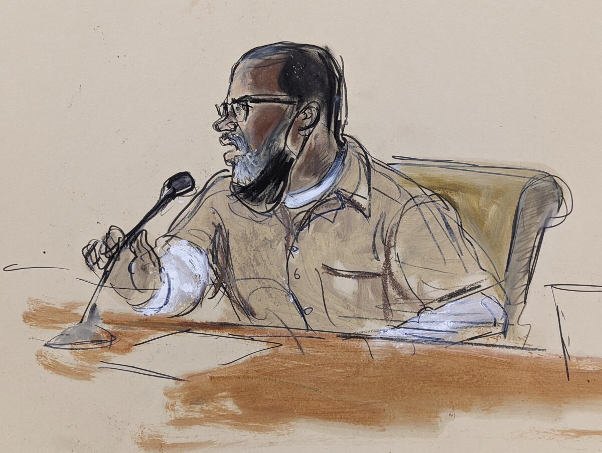 A courtroom sketch showing a man sitting behind table while holding a tabletop microphone