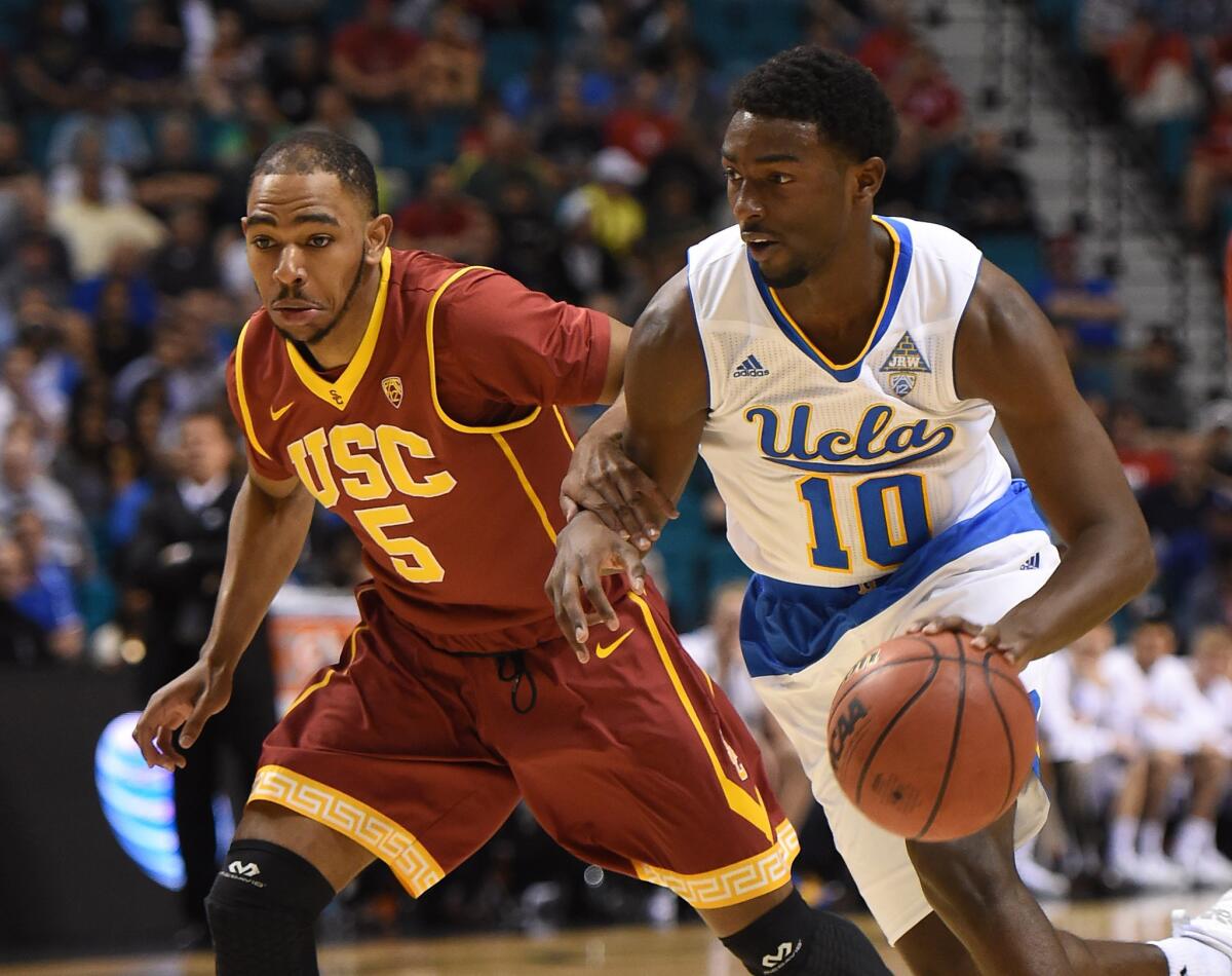 UCLA forward Isaac Hamilton drives past USC guard Kahlil Dukes during their Pac-12 Conference quarterfinal game Thursday at the MGM Grand Garden Arena in Las Vegas.