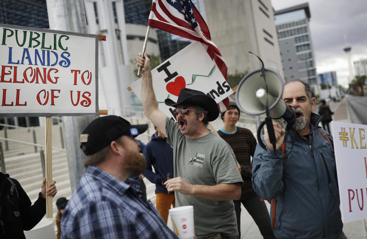 FILE - In this Feb. 6, 2017, file photo, supporters and critics of defenders of Cliven Bundy, who was on trial over an armed standoff with federal prosecutors gather at the federal courthouse in Las Vegas. Todd Engel, who has served more than four years in federal custody for his part in the armed 2014 standoff against federal agents in support of states rights advocate Bundy, filed suit against the U.S. government and prosecutors for damages in a civil rights and conspiracy complaint filed Sept. 7, 2021 in U.S. District court in Las Vegas. A federal court judge in 2018 found flagrant prosecutorial misconduct and dismissed criminal charges against Bundy and more than a dozen other defendants, including Engel. Engel is seeking $100 million for damages. (AP Photo/John Locher, File)