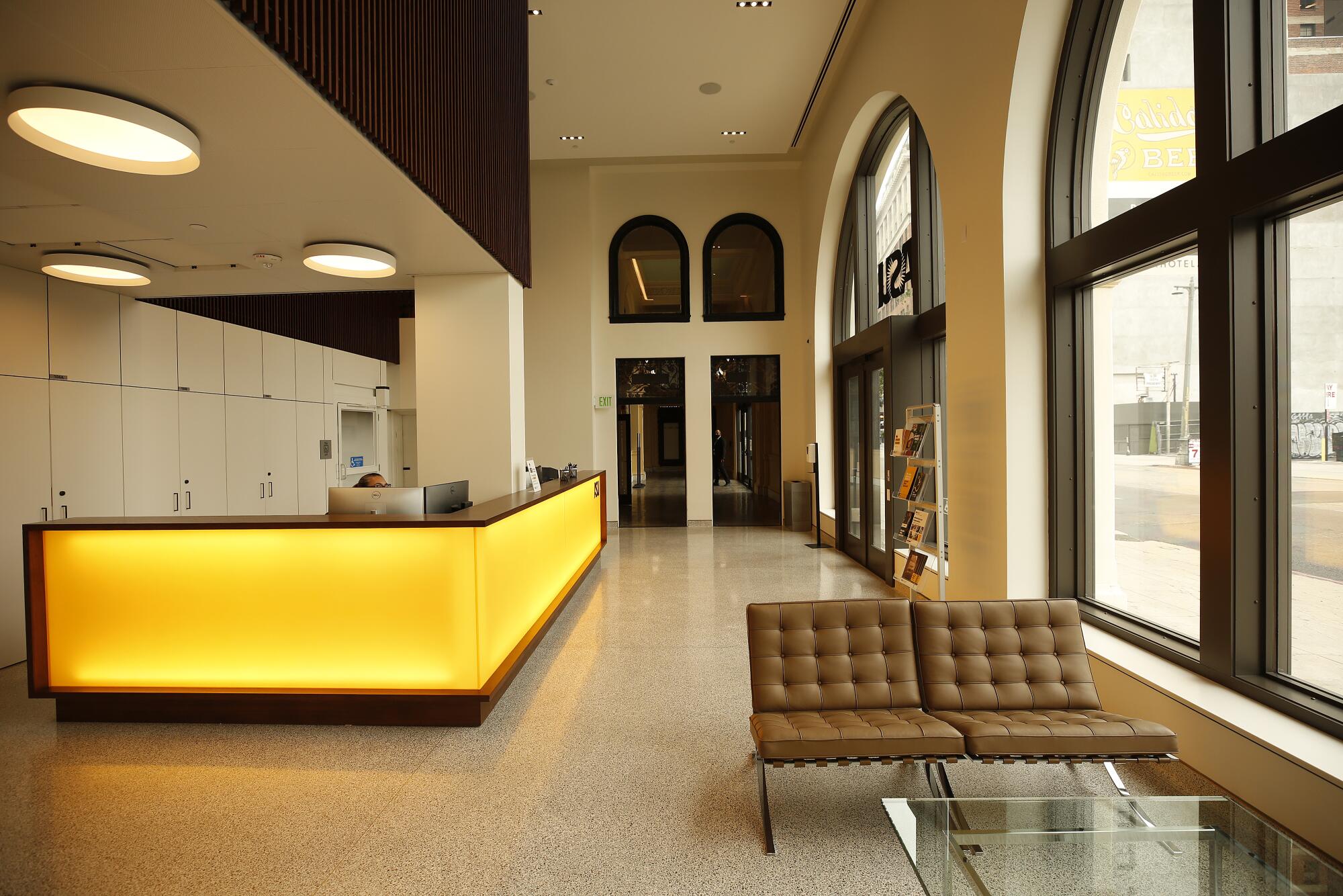 A view of ASU's new lobby area features a bright yellow counter and windows that overlook Broadway.