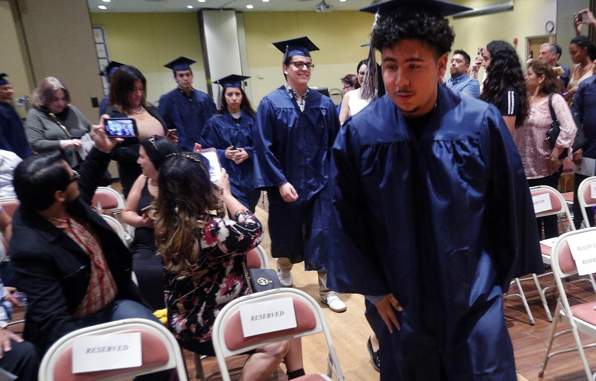 Daily High School student Brian Aguilera leads his fellow graduates into a ceremony for the Glendale Unified School District's 2019 summer graduation at First United Methodist Church in Glendale on Friday. High schools included in the graduation were Daily, Clark Magnet, Crescenta Valley, Hoover, Glendale and Verdugo Academy.