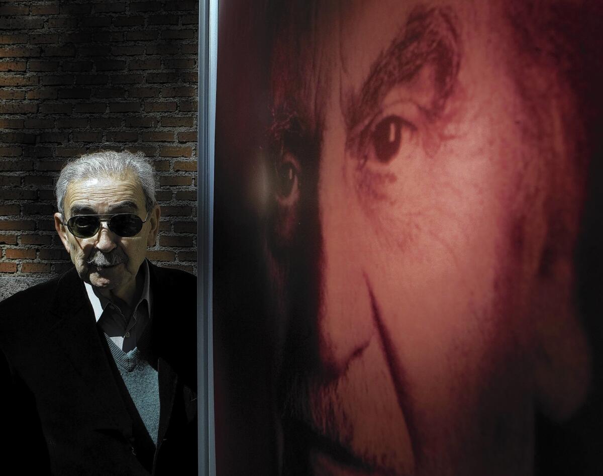 Poet Juan Gelman, shown at a 2008 exhibition in Madrid about Cervantes Prize winners, died Tuesday after battling leukemia.