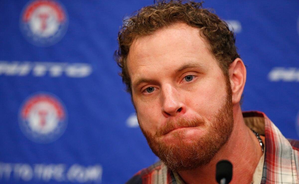 Josh Hamilton talks during a news conference after being traded to the Texas Rangers.