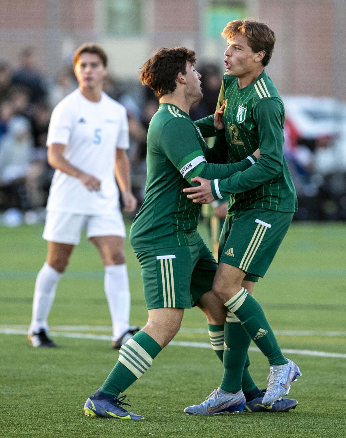 Edison's Tai Khoshkbariie, left, celebrates with Mikey White, right, after he scores a goal against Corona del Mar.