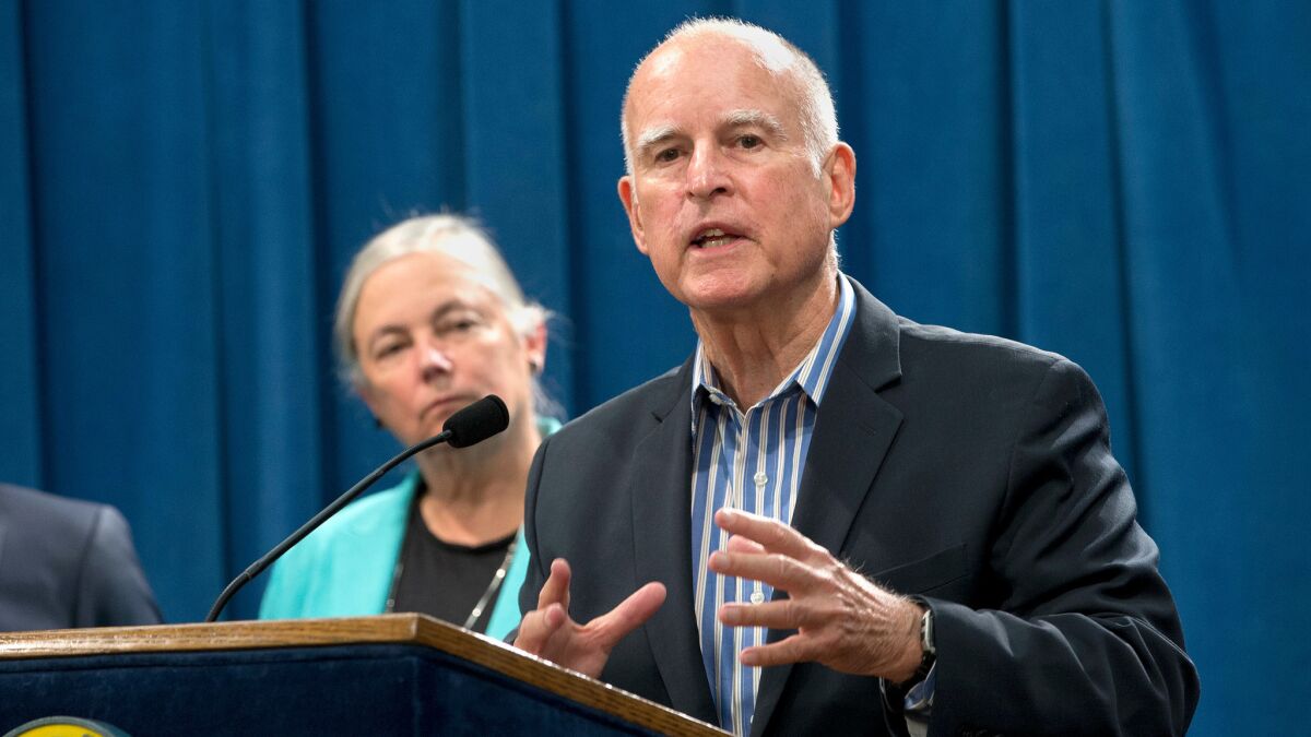 Gov. Jerry Brown talks with reporters about new climate legislation approved by lawmakers Wednesday.