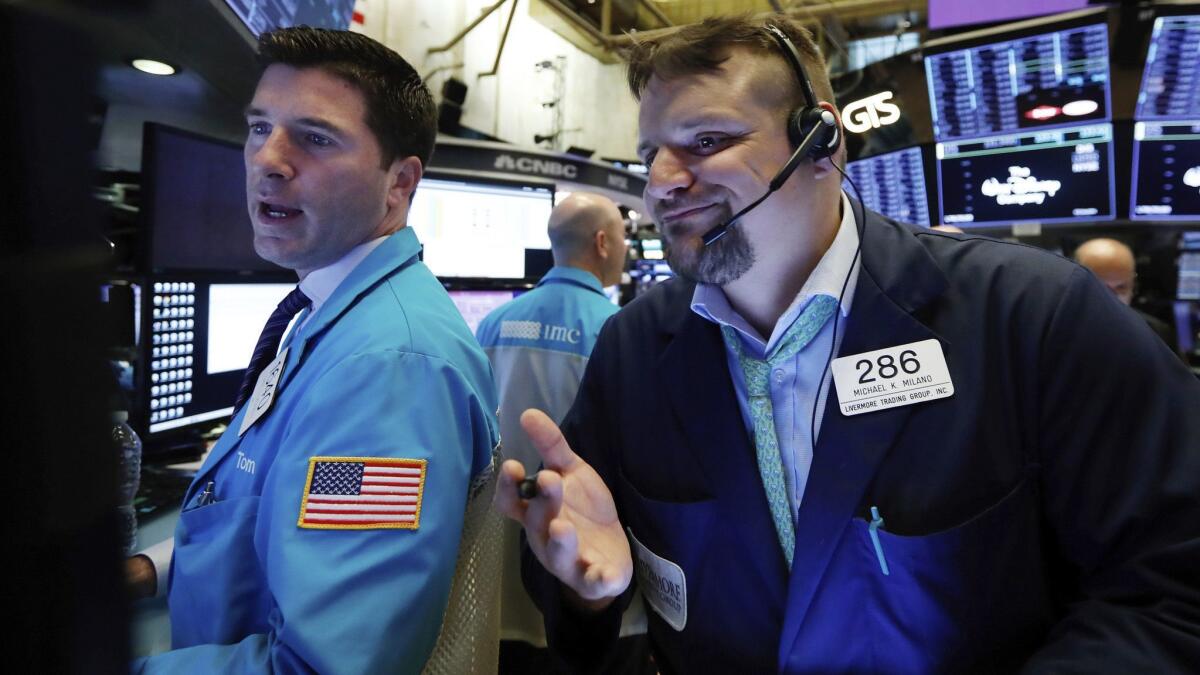 Specialist Thomas McArdle, left, and trader Michael Milano work on the floor of the New York Stock Exchange.
