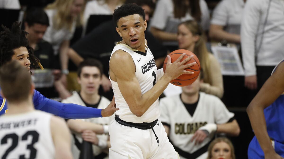 Colorado guard Tyler Bey looks to pass during a game in February.