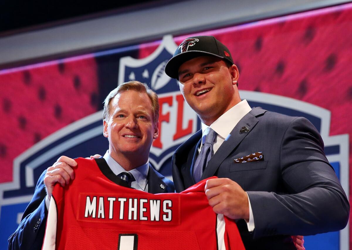 Texas A&M's Jake Matthews poses with Commissioner Roger Goodell after he was picked sixth overall by the Atlanta Falcons in the NFL draft.