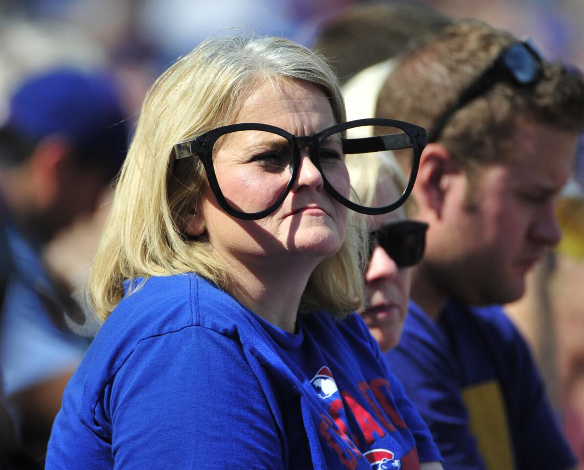 A fan watches the game between the Cubs and the Braves during the first inning at Wrigley Field.