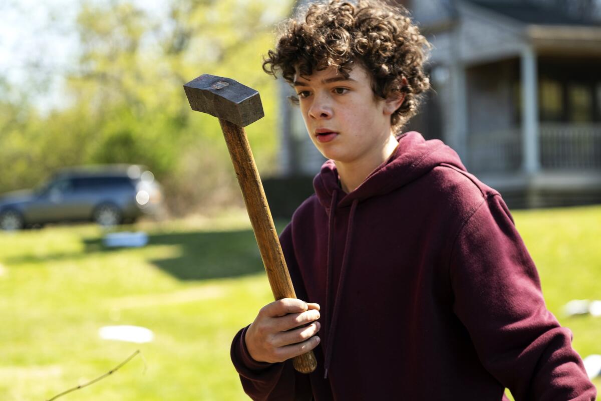Noah Jupe holding a hammer in a scene from "The Undoing."