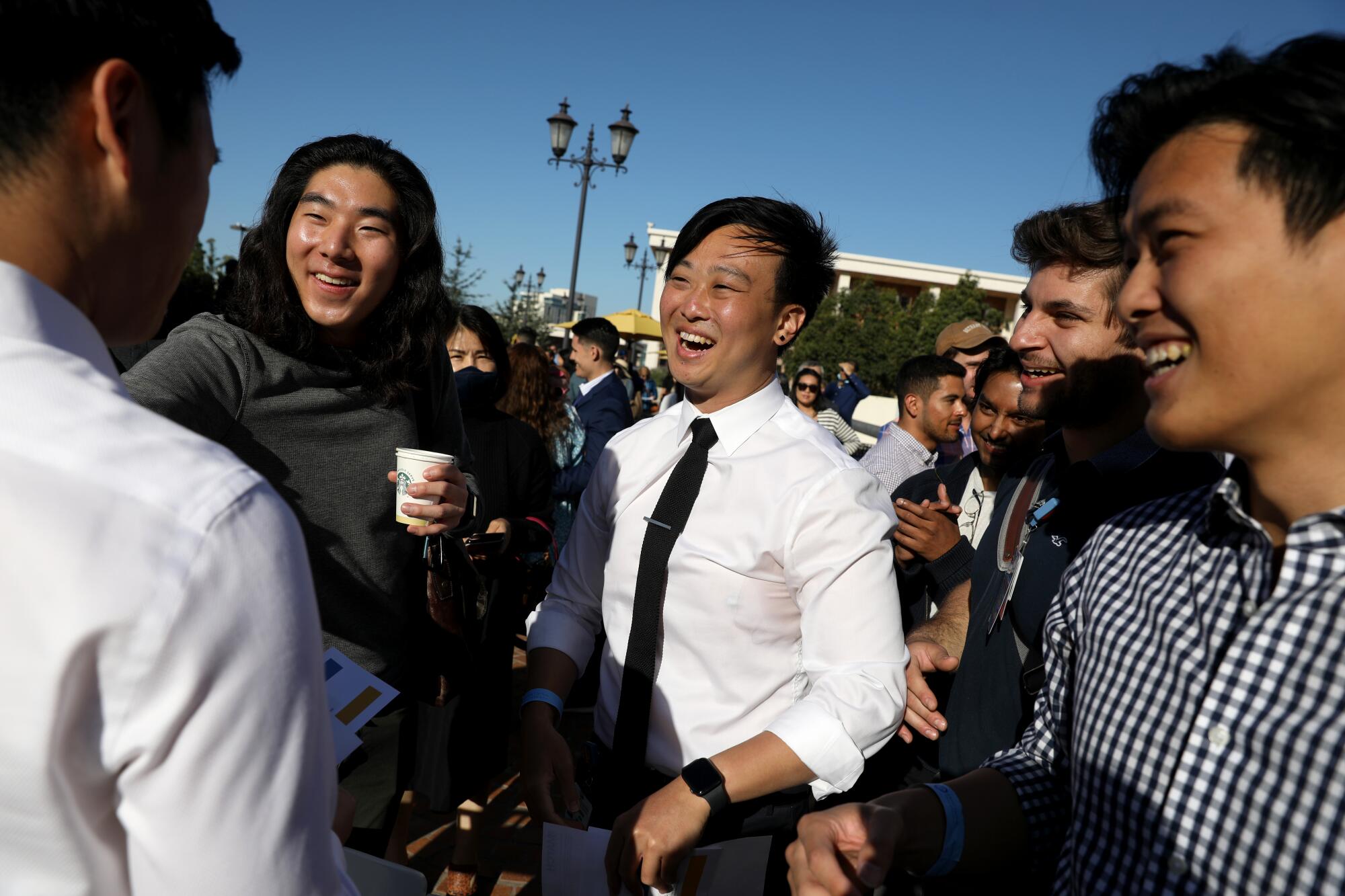 UCLA medical students talk and laugh outdoors