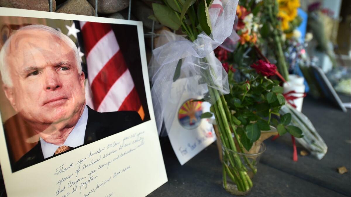 Photographs, flowers and notes at a makeshift memorial outside Sen. John McCain's office in Phoenix on Aug. 26.