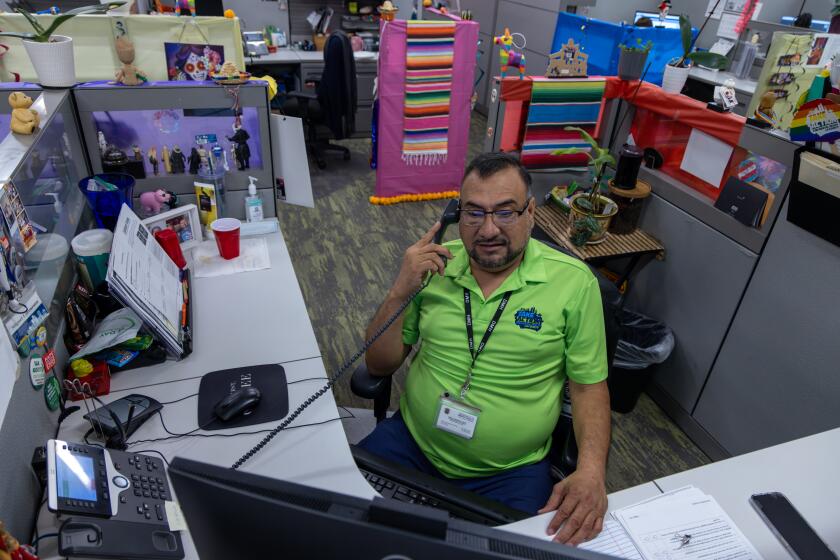 COVINA, CA - OCTOBER 25: Miguel Lorenzana, substance abuse counselor, on phone with a client from his cubicle at East San Gabriel Valley Mental Health Center on Wednesday, Oct. 25, 2023 in Covina, CA. (Irfan Khan / Los Angeles Times)