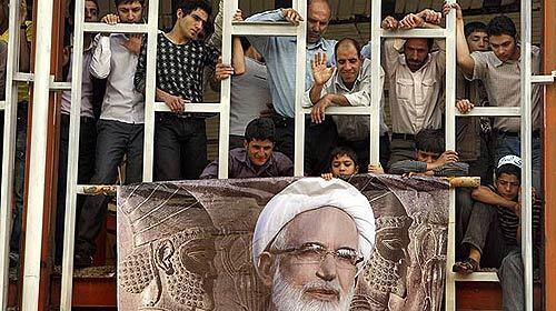 Campaigning ramps up as Iran nears a presidential election on June 12. A large image of Mehdi Karroubi, a moderate cleric and strong critic of President Mahmoud Ahmadinejad, heralds Karroubi's appearance in his hometown of Aligudarz, about 240 miles southwest of Tehran. Observers occupy a building under construction.