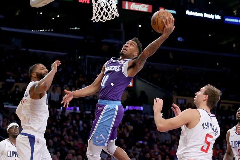 LOS ANGELES, CALIF. - DEC. 3, 2021. Lakers guard Malik Monk drives and scores against the Clippers in the fourth quarter of Friday night's game, Dec. 3, 2021, in Los Angeles. (Luis Sinco / Los Angeles Times)