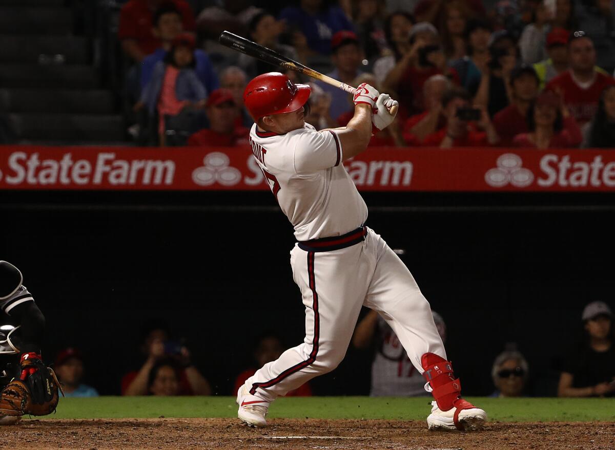 The Angels' Mike Trout connects for a two-run single against the White Sox on Aug. 17, 2019.