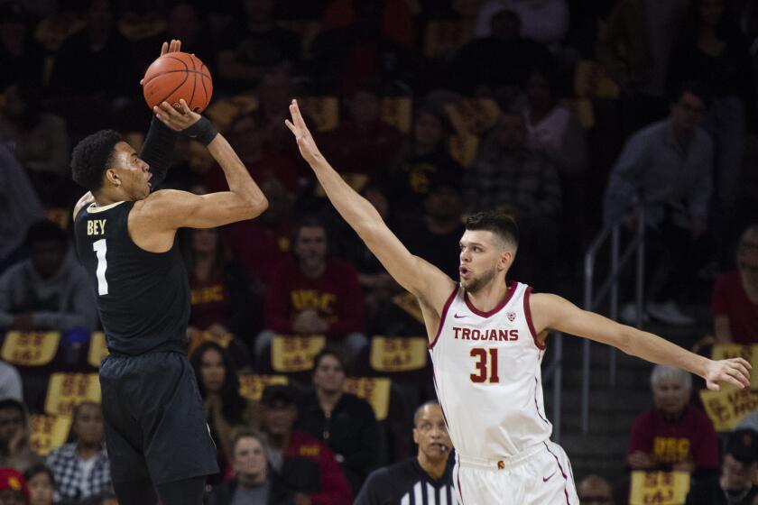 Colorado guard Tyler Bey, left, shoots over Southern California forward Nick Rakocevic during the first half of an NCAA college basketball game Saturday, Feb. 1, 2020 in Los Angeles. (AP Photo/Kyusung Gong)