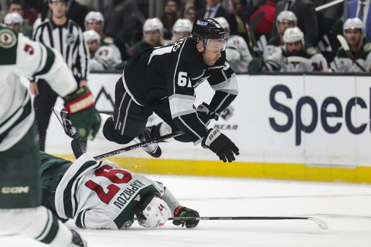 Kings center Trevor Lewis trips over Wild left wing Kirill Kaprizov in the second period.