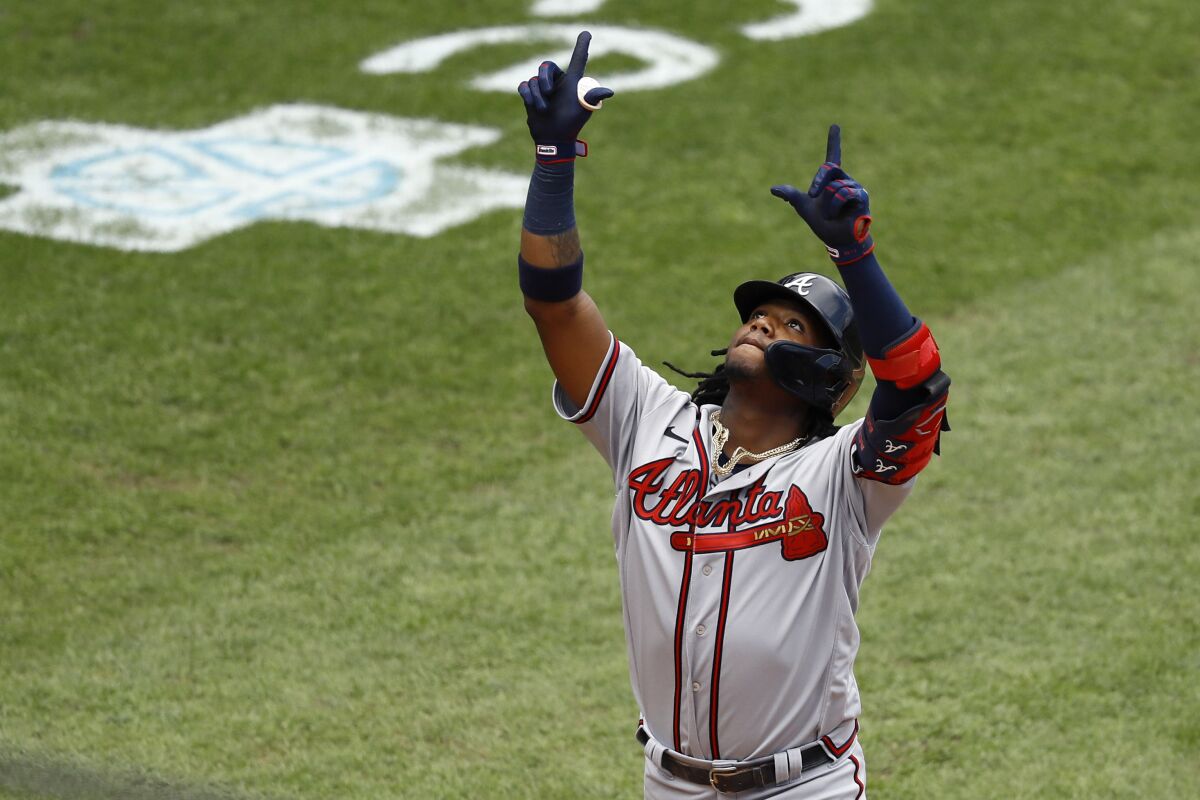 Atlanta Braves' Ronald Acuna Jr. reacts after hitting a two-run home run off Philadelphia Phillies relief pitcher Deolis Guerra during the fifth inning of the first baseball game in a doubleheader, Sunday, Aug. 9, 2020, in Philadelphia. (AP Photo/Matt Slocum)