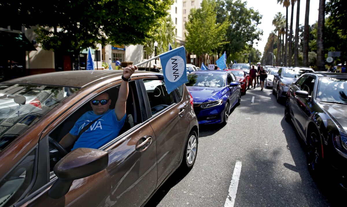 Drivers for Uber and Lyft and their supporters rallied in Sacramento this week for a bill that would limit the ability of companies to label workers as independent contractors.