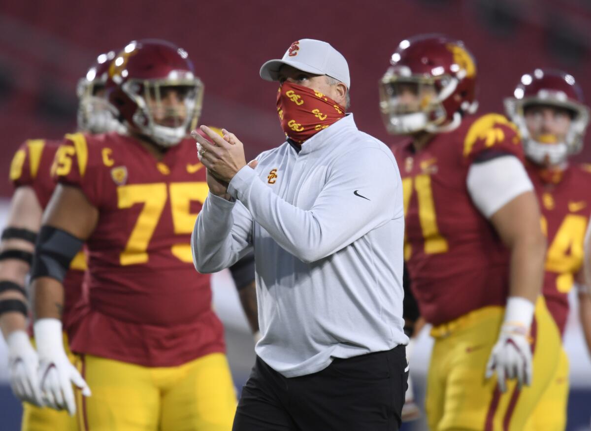 USC coach Clay Helton claps before the Trojans play Oregon in the Pac-12 title game.